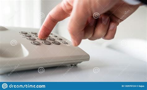 Low Angle Closeup View Of Male Hand Dialing A Phone Number Stock Photo