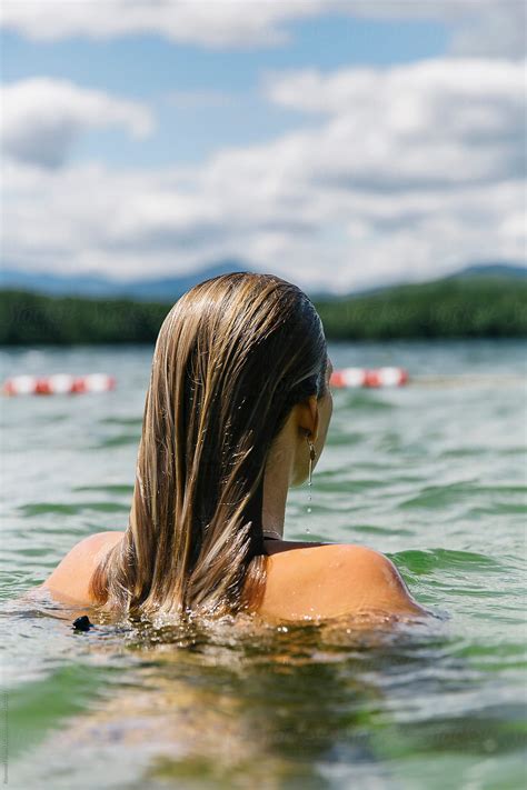 Portrait Of Beautiful Young Girl With Wet Hair Swimming At Lake By