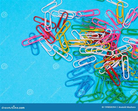 Collection Of Colorful Paper Clips On Blue Background Stock Photo