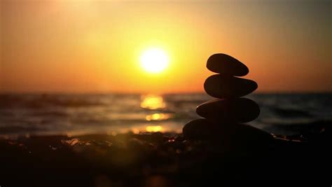 Beach Sunset Man Build Zen Symbol From Stones On The Beach At