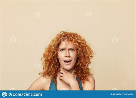 redhead woman surprised girl close up portrait blue eyed female with curly red hair touching
