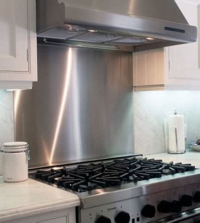 Starting at one end, use a clean, soft rag to smooth the stainless steel backsplash into place and remove any air bubbles. Stainless Steel Backsplash | Frigo Design