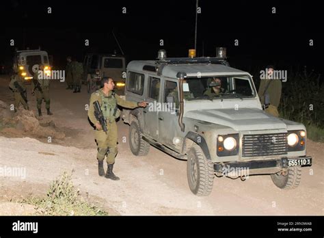 Israeli soldiers patrol on the border with Syria near the town of