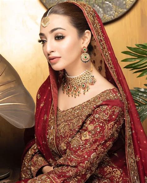 A Woman Wearing A Red And Gold Bridal Outfit
