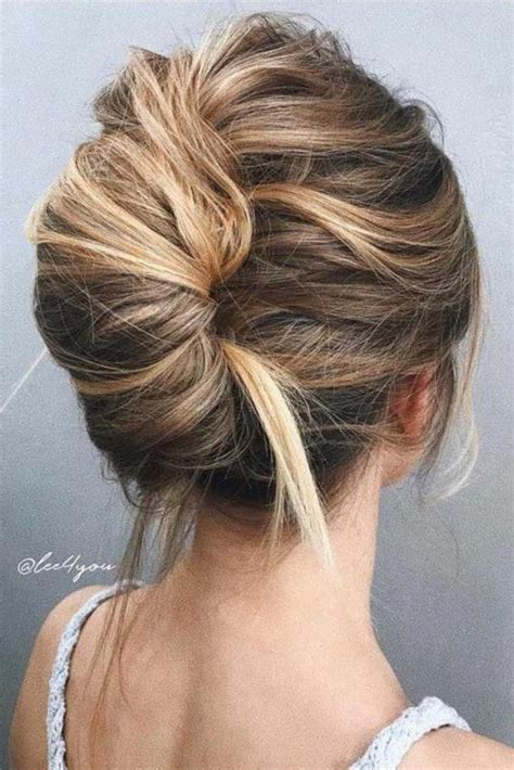 A Super Messy And Bold French Twist Updo With A Messy Volume On Top And