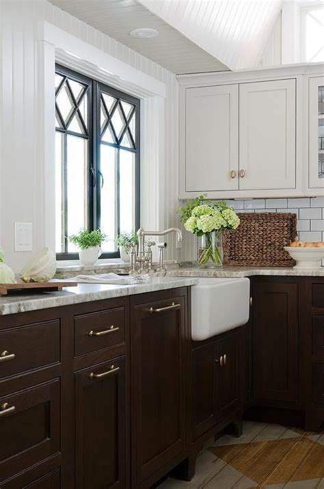 In the past, stained natural wood cabinets dominated every kitchen. Gorgeous kitchen features light grey upper cabinets and ...