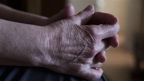 Wrinkled hands of an old woman, closeup. The parched skin of the old ...