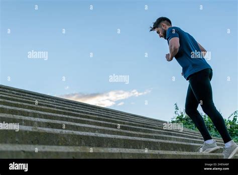 Young Man Climbing Stairs In The Park Stock Photo Alamy