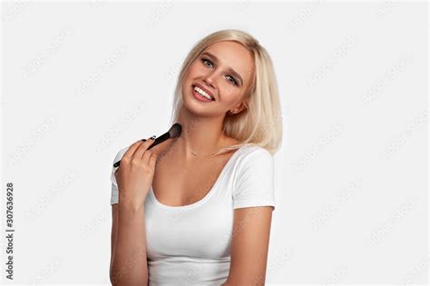 Beautiful Blonde Girl Applies Skin Tone With Brush Sexy Woman Portrait