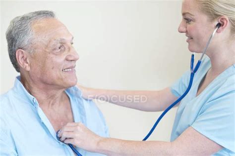 Female Doctor Examining Patient With Stethoscope — Examination