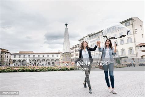 Lesbian Couple Holding Umbrella Fooling Around Holding Hands Smiling Piazza Santa Maria Novella