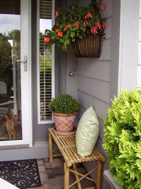 Two Potted Plants Are Sitting On A Small Bench In Front Of A Door Way