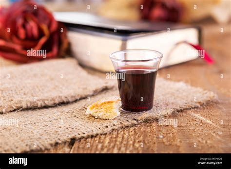 Taking Communion Cup Of Glass With Red Wine Bread And Holy Bible On