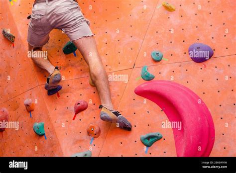 Fit Man Rock Climbing Indoors At The Bouldering Gym Legs Close Up