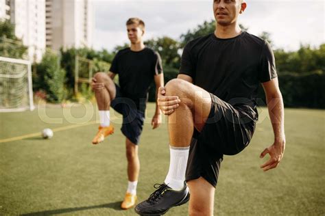 Male Soccer Players Doing Stretching Exercise Stock Image Colourbox
