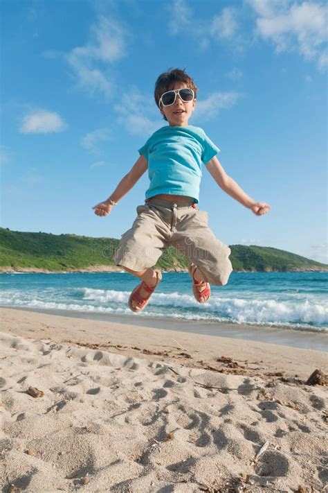 Young Boy Jump In The Sea Stock Photo Image Of Beauty 26154888