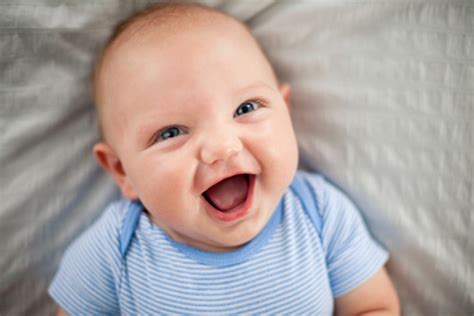Happy Laughing Baby Boy Lying On Textured Fabric Stock