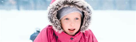 Funny Caucasian Girl In Warm Winter Clothes Playing With Snow Cute