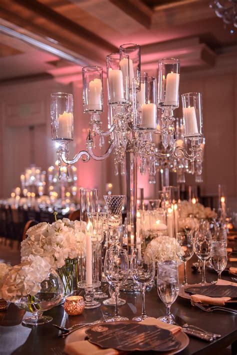 An Elegant Centerpiece With Candles And Flowers