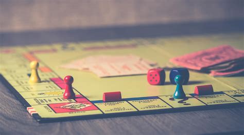 Monopoly Board Game On Brown Wooden Tabletop · Free Stock Photo