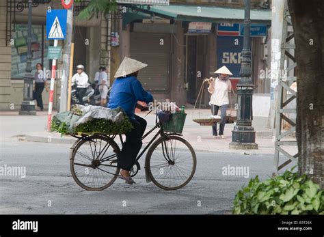 An Elderly Vietnamese Woman Going To The Market By Bicycle To Sell Her Vegetables Hanoi