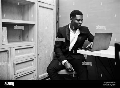 Strong Powerful African American Man In Black Suit Sitting And Working