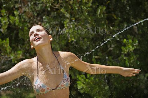 Teenage Girl Being Sprayed With Water 7852203 の写真素材 アフロ