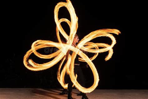 Woman Artist Perform Fiery Twirly Trails By Spinning Flaming Pois