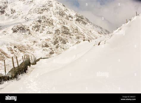 Massive Snow Drifts Block The Kirkstone Pass Road Above Ambleside In