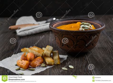 Pumpkin Cream Soup In A Clay Bowl With Snack Fried