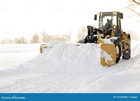 A Big Yellow Snow Plow Cleaning A Road Stock Photo Image Of Hard