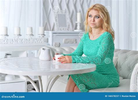 Beautiful Mature Woman Sitting At Light Kitchen Stock Image Image Of