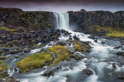 Oxararfoss Waterfall And The River Oxara Set Within A Volcanic