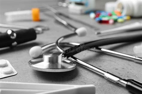 Stethoscope And Different Medical Objects On Grey Table Stock Image