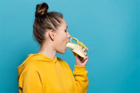 pretty girl putting a banana in her mouth stock image image of food casual 165190737