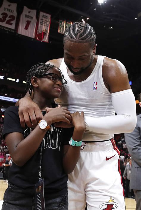 dwyane wade 3 of the miami heat hugs his son zion wade after his final career home game at
