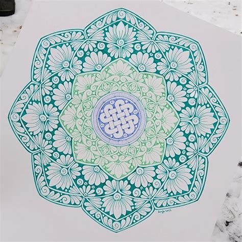 A Blue And Green Design On White Paper