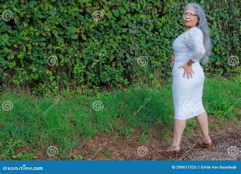 full body mature woman in elegant white dress standing with torso turned stock image image of