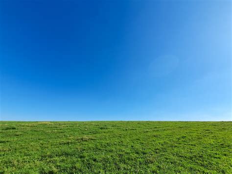 Green Grass Blades And Clouds With Blue Sky Background Stock Photo 3a5