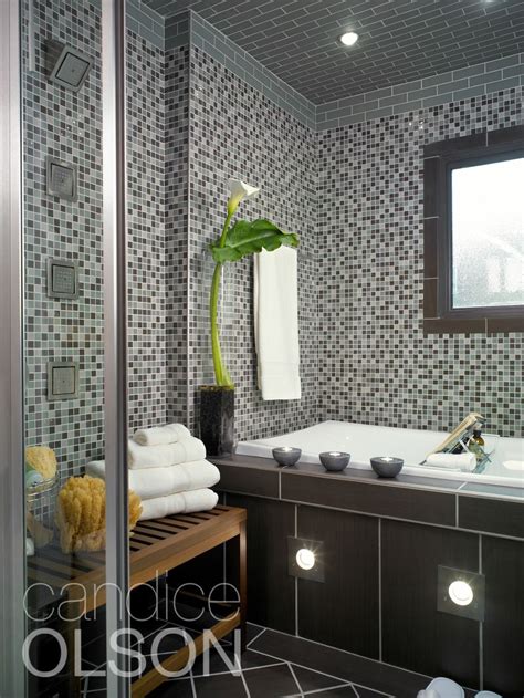 Rich mahogany cabinets, white quartz countertops, marble mosaic tile and sleek vessel sinks are among the fine finishes in this bathroom. This ambient lighting in a home spa creates an environment ...