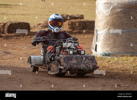 A racing lawn mower driver from the team "Mack and his Mate" takes a
