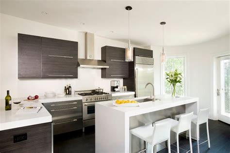 This kitchen is dominantly white but at least the countertops are black since these get the most stains and spills. 15 Beautiful L-Shaped Kitchens | Home Design Lover