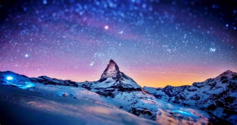 The Night Sky Is Filled With Stars Above A Snowy Mountain Range And