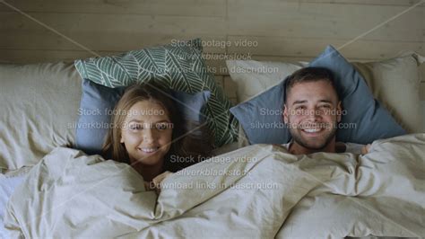 Top View Of Smiling Couple Having Fun In Bed Hiding Under Blanket And Looking Into Camera Youtube