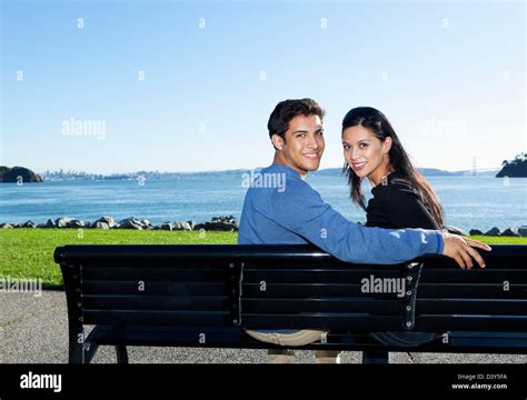 Mixed Race Couple Sitting On Park Bench Stock Photo Alamy