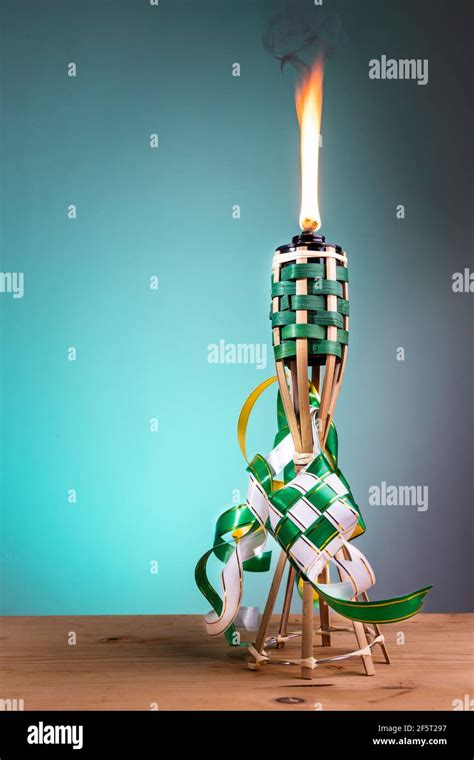 Traditional Malay Torch And Decorative Ketupat Lit Up During Hari Raya