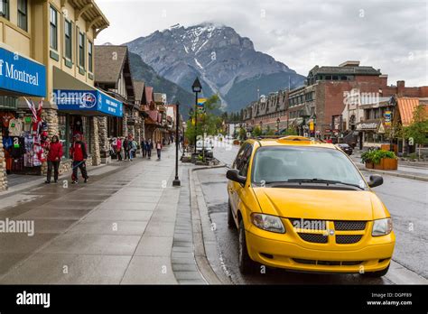 Main Street With Yellow Taxi In Banff Alberta Canada Stock Photo Alamy