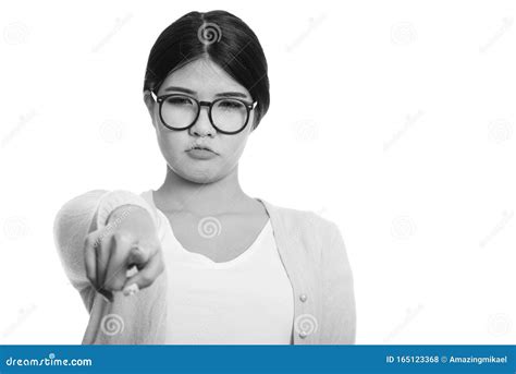 Young Asian Nerd Woman Looking Angry While Pointing Finger At Camera