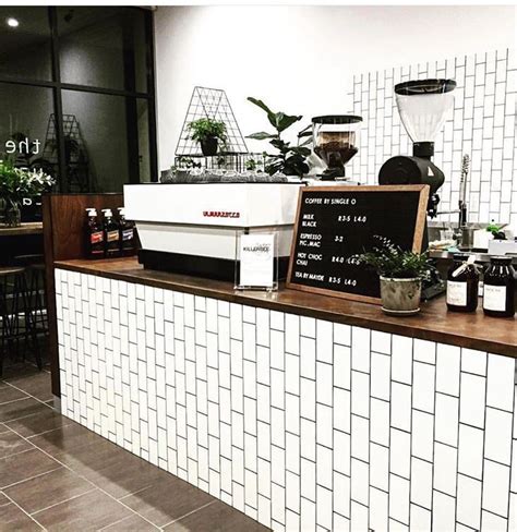 A Coffee Shop Counter With Plants On It