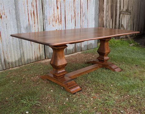 Farmhouse dining tables typically feature natural wood or distressed paint finishes. Farmhouse Trestle Table